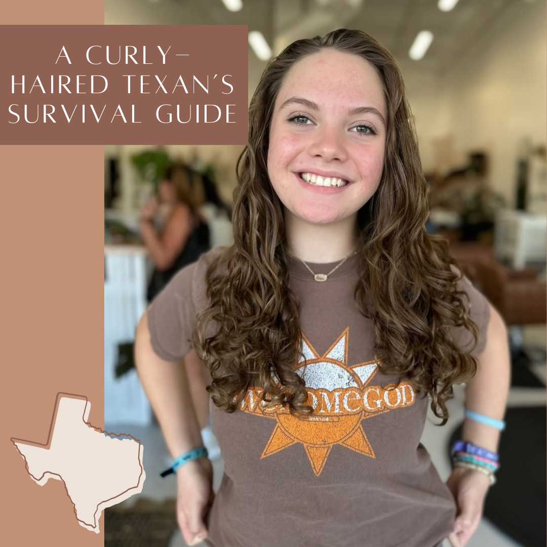 Smiling woman with long, natural brunette curls wearing a graphic t-shirt in a hair salon setting, with graphic text reading "A Curly-Haired Texan's Survival Guide".