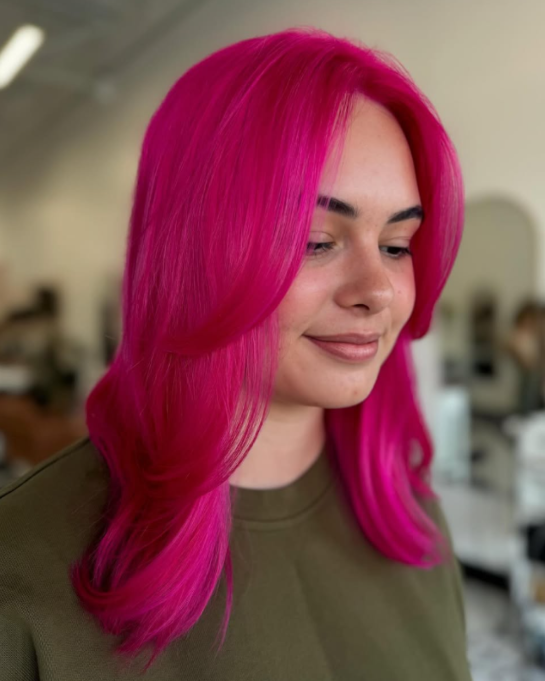Vibrant, all-over bright pink hair color and blowout by Zoe.