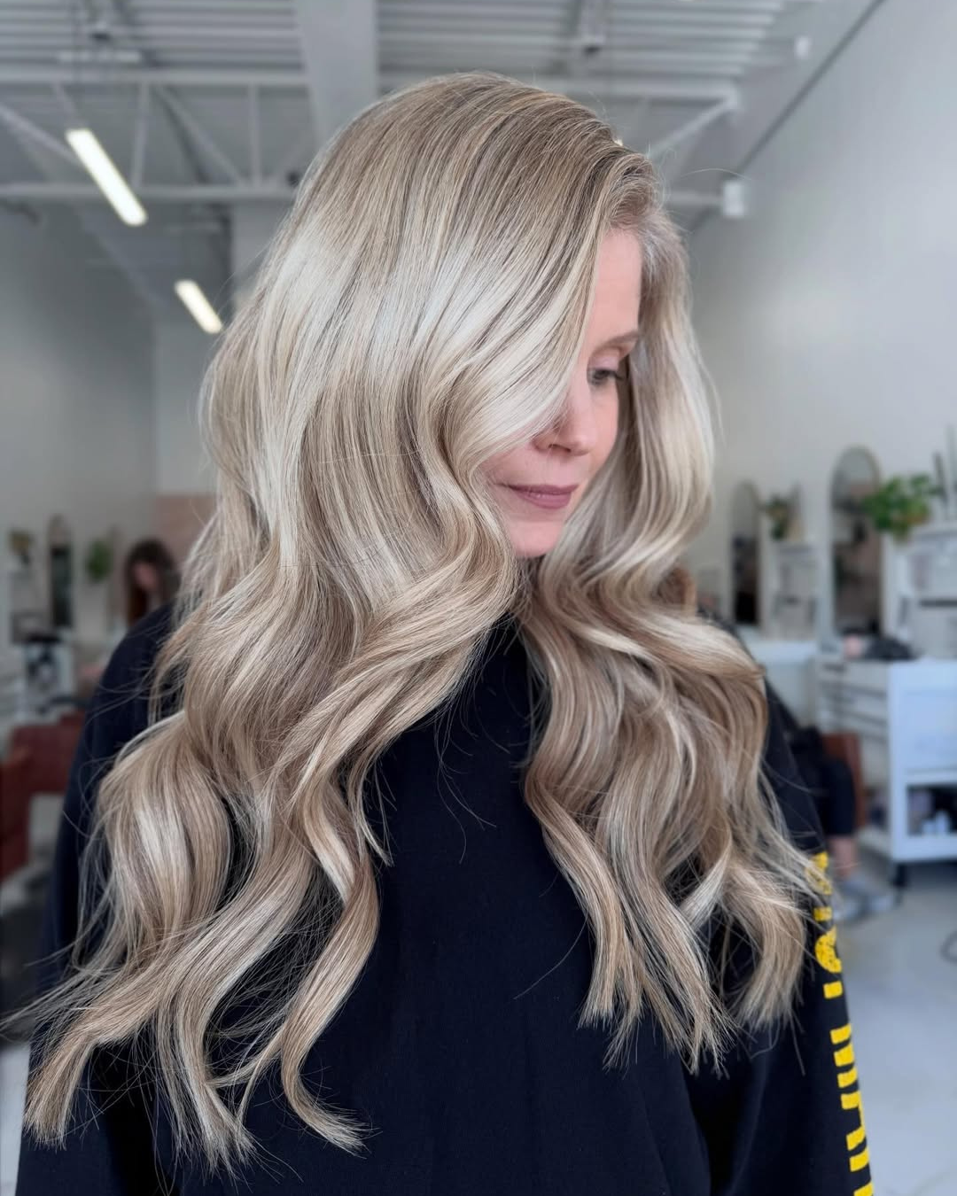 Bright platinum blonde long hairstyle with custom blonding and extensions by Jessica.