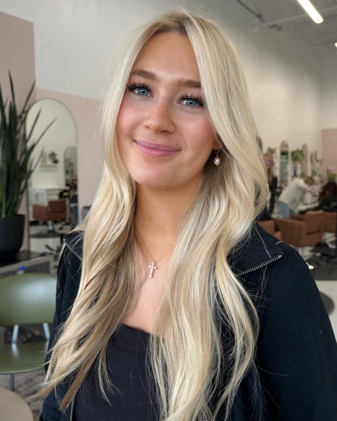 Bright platinum blonde highlights and styling on long hair by Jessica.