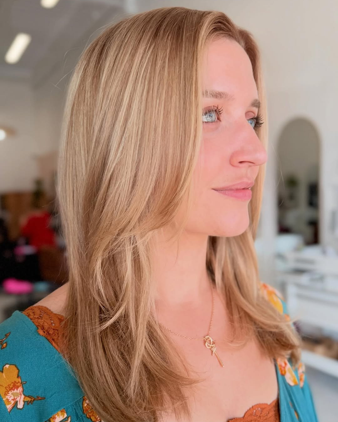 Warm golden blonde highlights and layered haircut by Jessica.