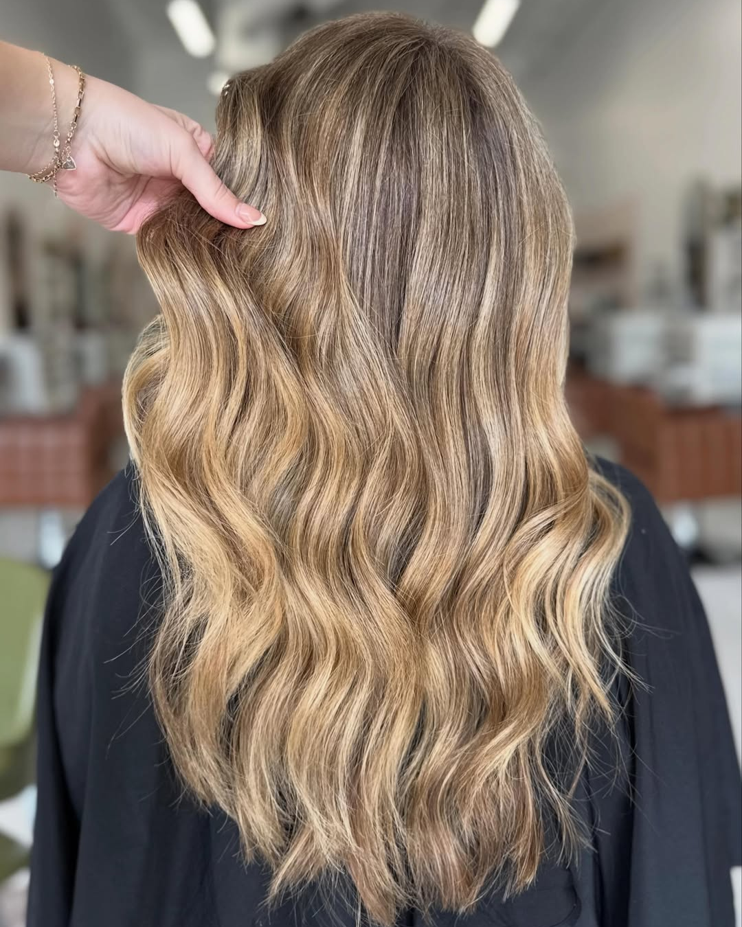 Long sunkissed blonde layered hair with soft waves by Katie.